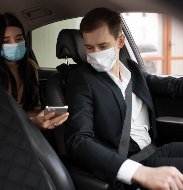 elegant-taxi-driver-and-client-in-car-with-medical-masks (1)